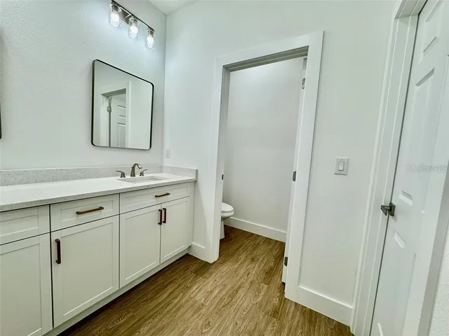 a spacious bathroom with 2 sink and a toilet