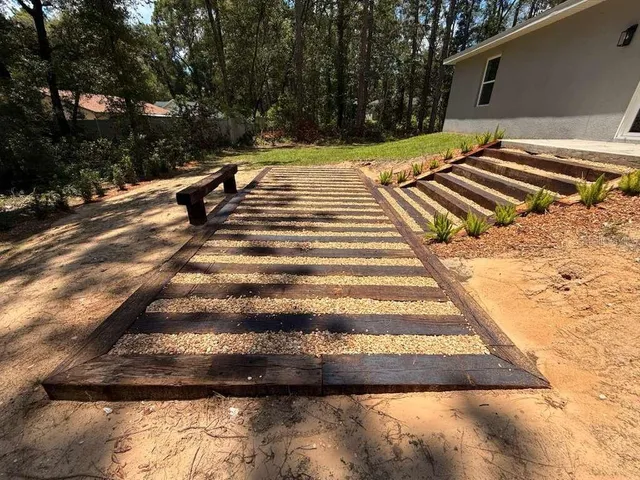 a view of backyard with wooden fence