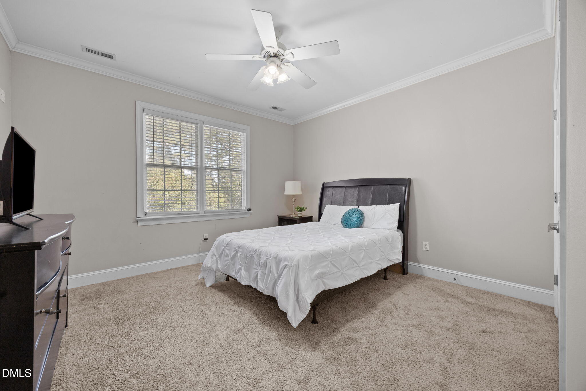 3689 Graham Sherron Road Wake Forest, NC 27587 - Photo 33 of 57 a spacious bedroom with a bed and a flat tv screen on the dresser