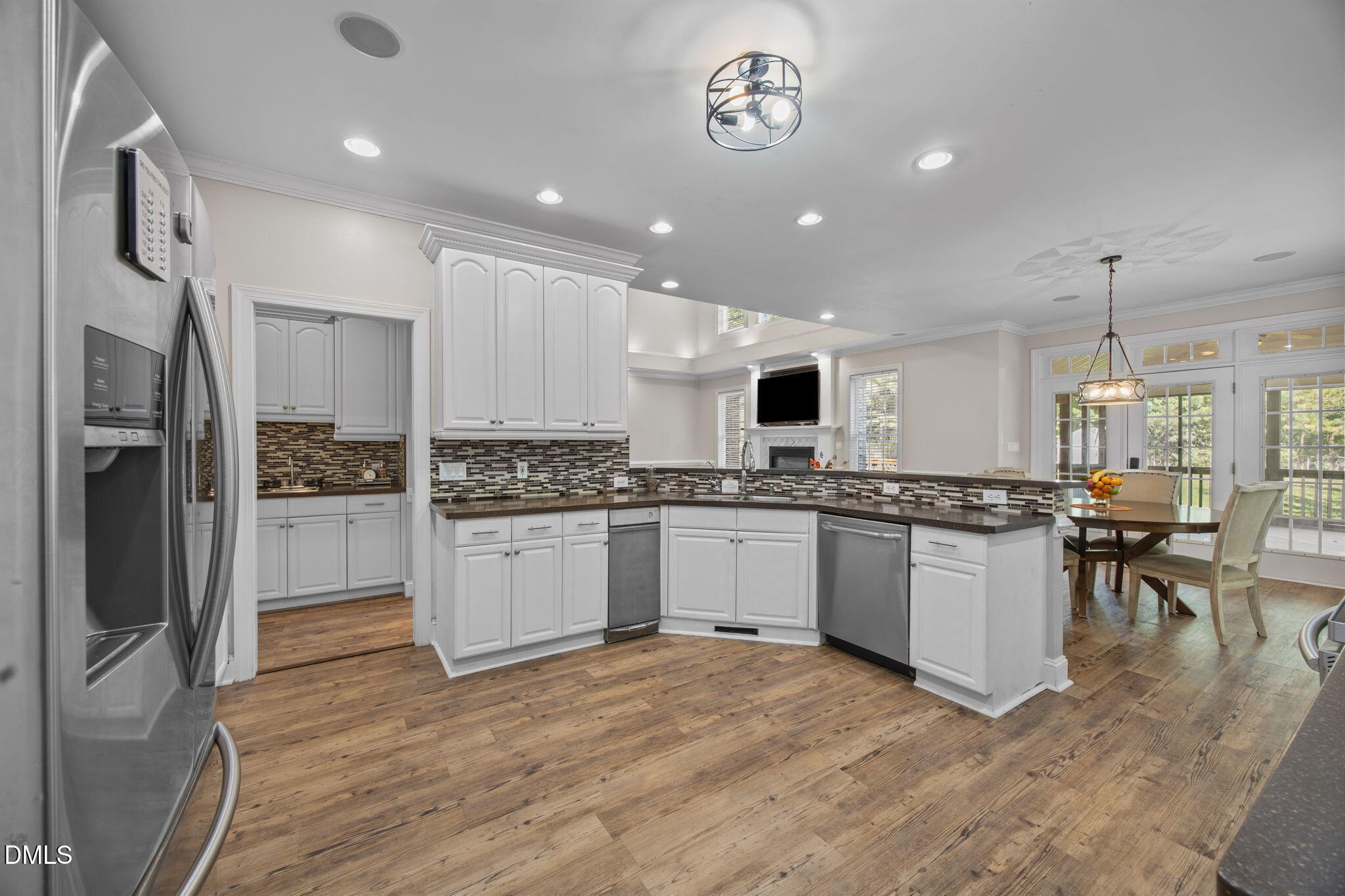 3689 Graham Sherron Road Wake Forest, NC 27587 - Photo 7 of 57 a kitchen with a refrigerator and white cabinets