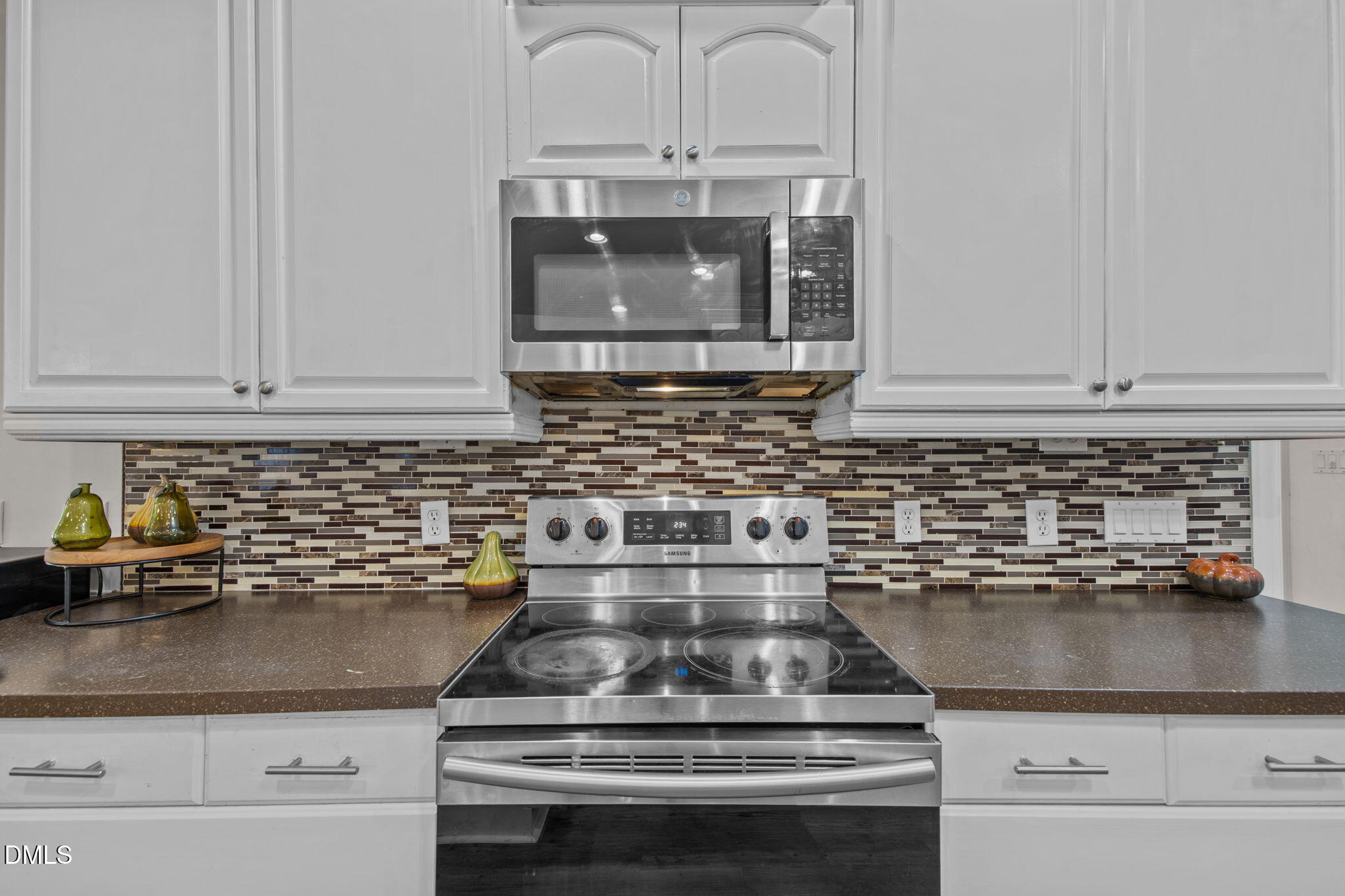 3689 Graham Sherron Road Wake Forest, NC 27587 - Photo 10 of 57 a kitchen with a stove and white cabinets