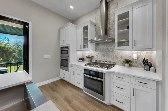 a kitchen with stainless steel appliances granite countertop a stove and a refrigerator