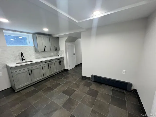 a large kitchen with a sink and cabinets