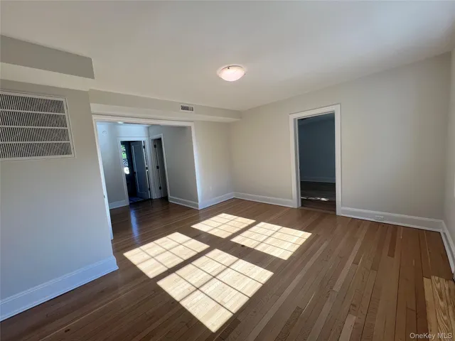 a view of wooden floor and a bathroom