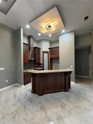 a kitchen with stainless steel appliances granite countertop a sink and cabinets