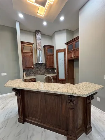 a bathroom with a granite countertop sink a toilet and mirror