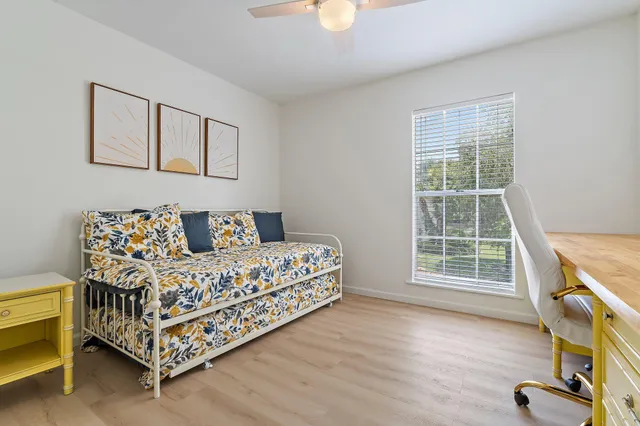 a bed room with a bed and a chair