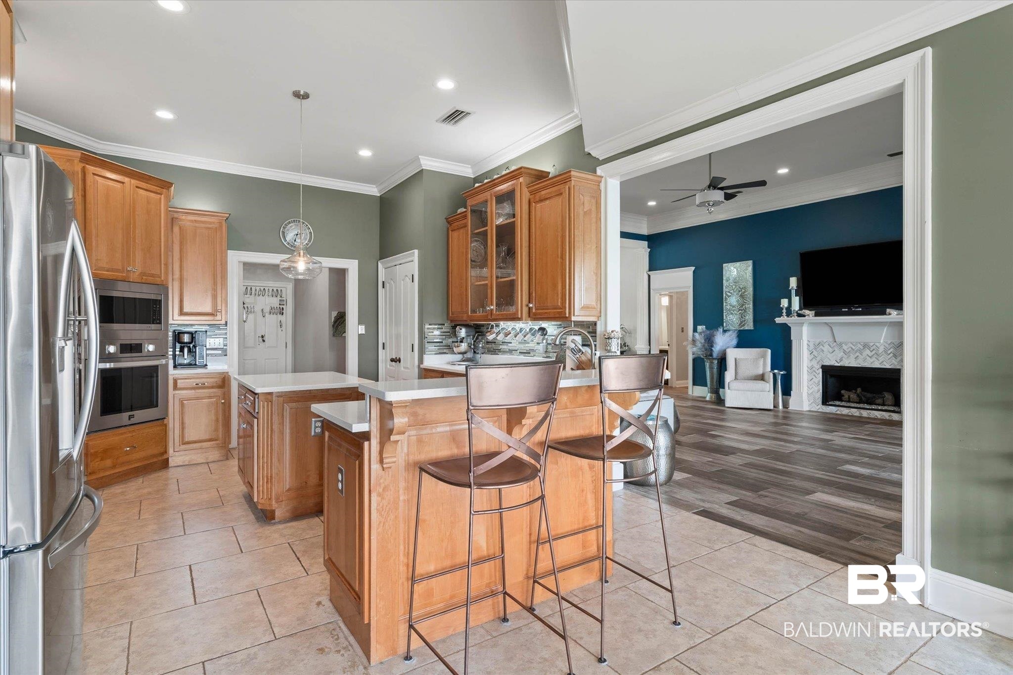 24908 Bosbyshell Avenue Daphne, AL 36526 - Photo 26 of 49 Kitchen featuring light wood cabinetry, stainless steel appliances, and two islands with light countertops