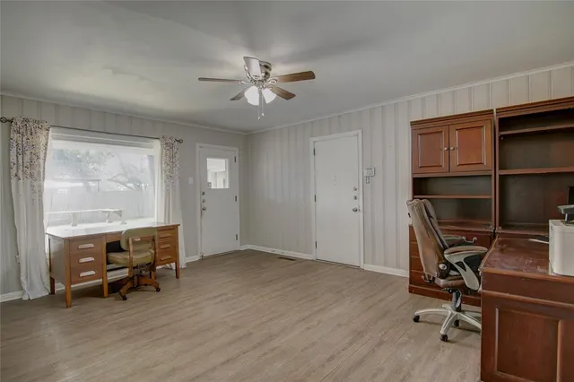a view of workspace with wooden floor and ceiling fan