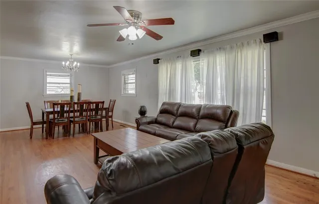 a living room with furniture and wooden floor