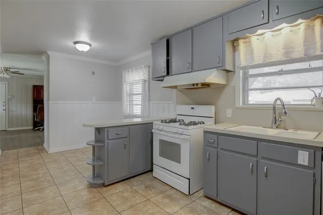 a kitchen with cabinets appliances and a sink