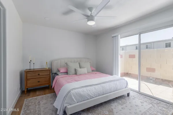 a bedroom with a bed and a large window