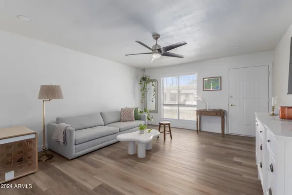 a living room with furniture and a wooden floor