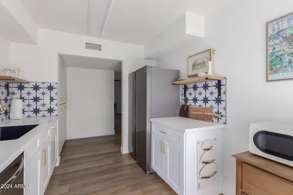 a kitchen that has a sink and a stove in it