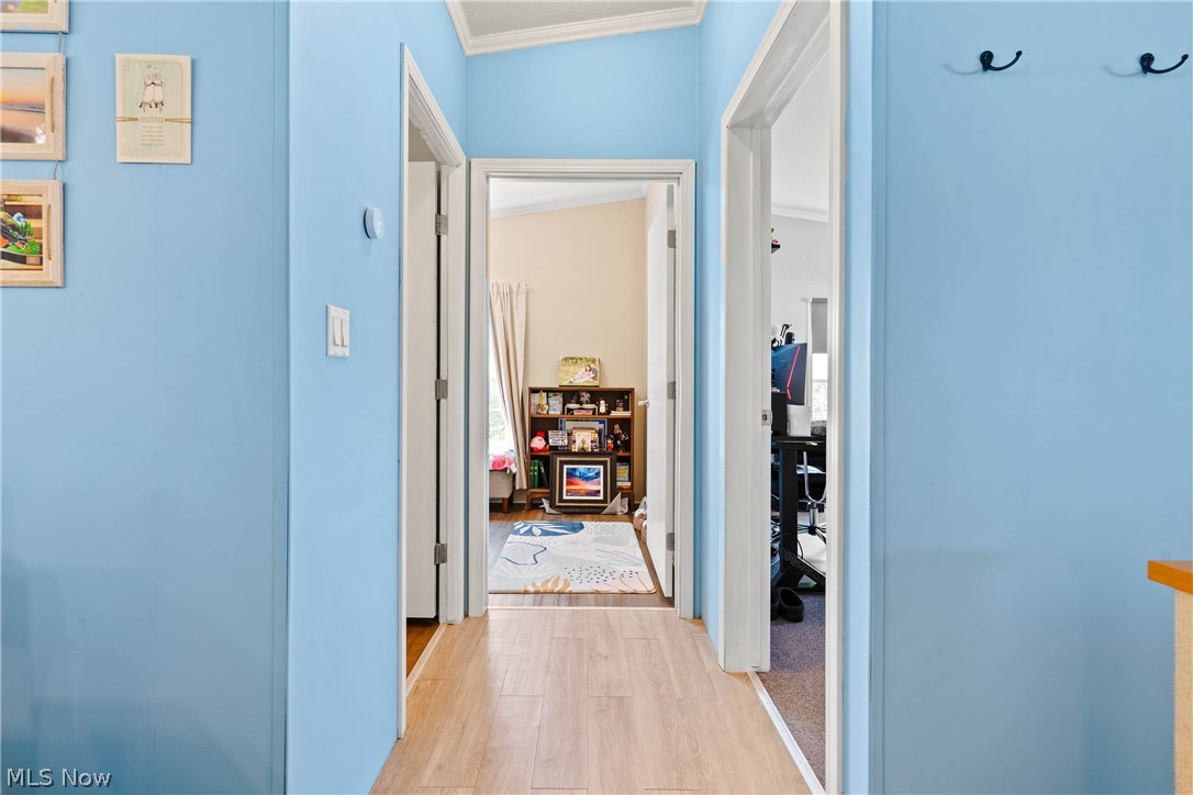 18592 Edwards Road, Unit 122 Doylestown, OH 44230 - Photo 15 of 27 Hall featuring ornamental molding and light wood-type flooring