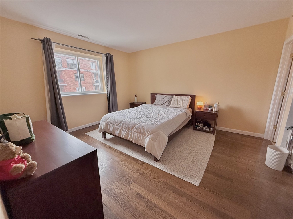 20 Stearns Road, Unit 45 Brookline, MA 02446 - Photo 9 of 22 a bedroom with a bed and wooden floor