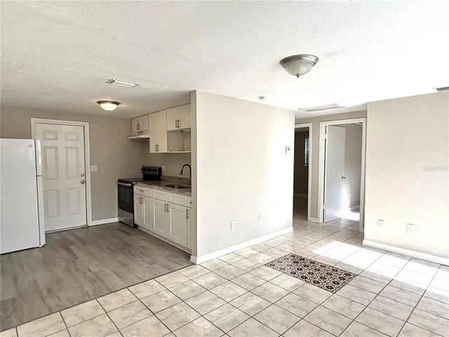 a kitchen with stainless steel appliances granite countertop a sink and a refrigerator