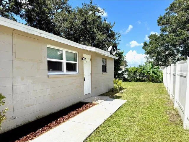 a backyard of a house with plants and trees
