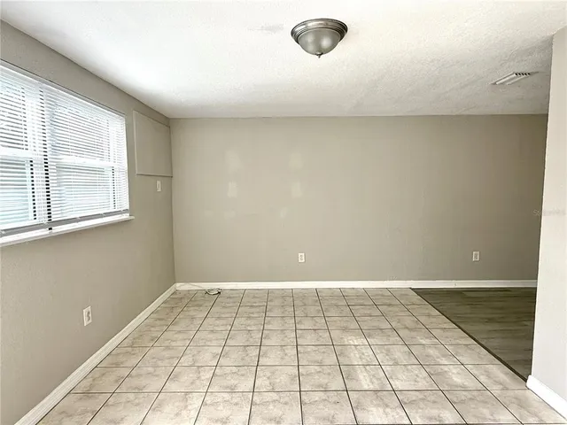 a kitchen with a refrigerator and white cabinets