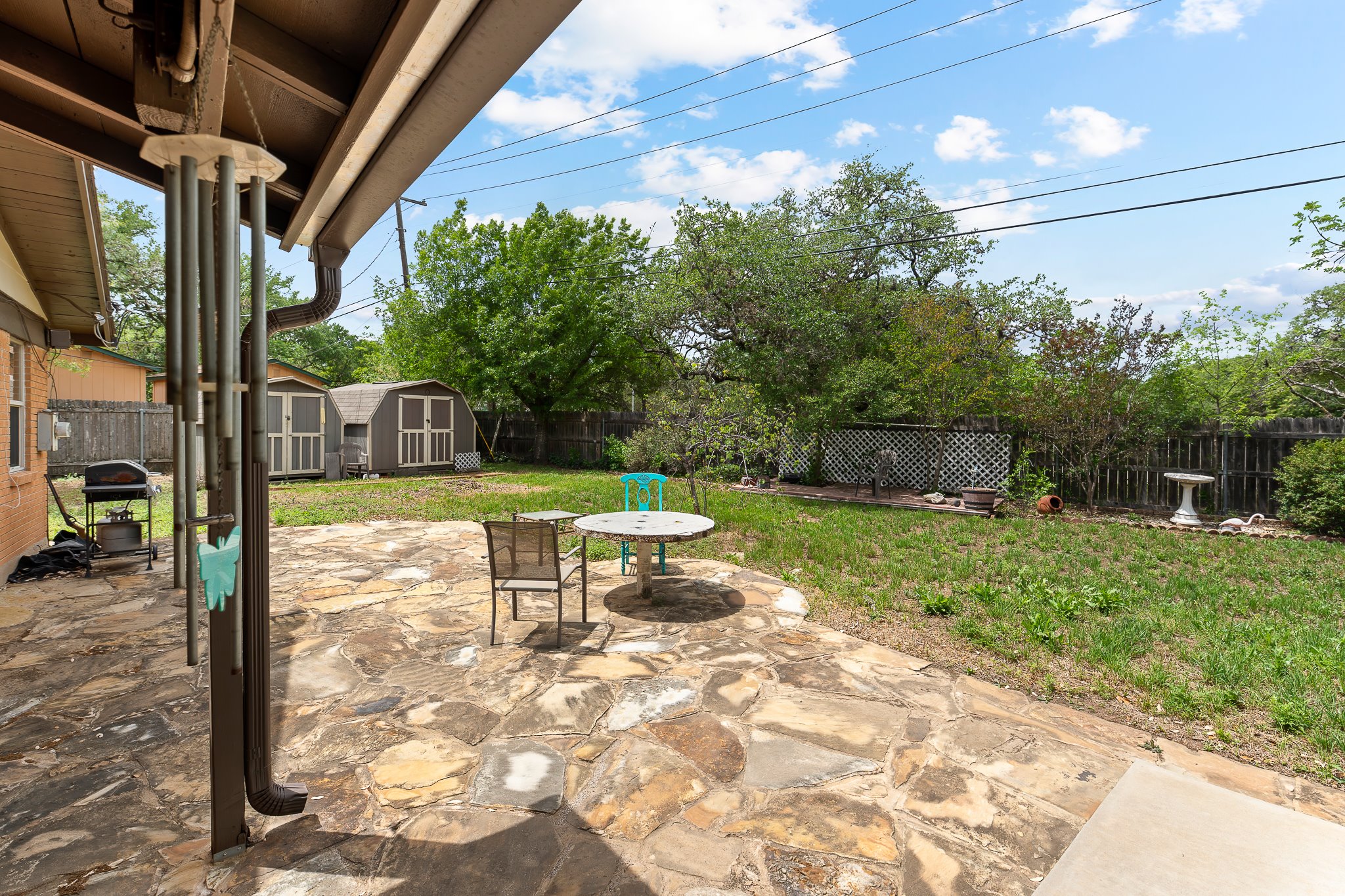 5600 Libyan Circle Austin, TX 78745 - Photo 32 of 37 Fenced backyard with a patio area, a storage shed, outdoor dining area, and a grill