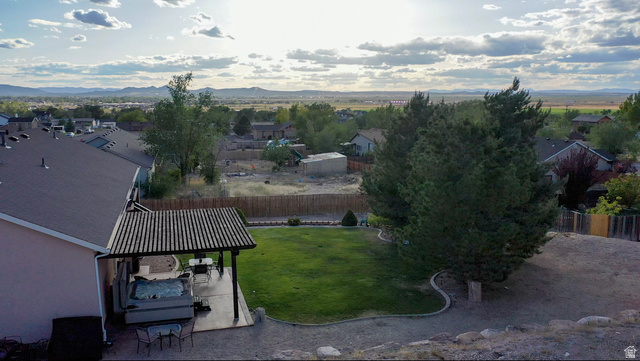 1797 Sunset Road Enoch, UT 84721 - Photo 6 of 80 Expansive backyard featuring a covered patio, hot tub, and a manicured lawn