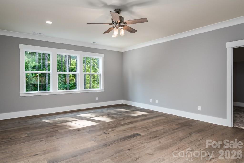 116 Silver Falls Road Troutman, NC 28166 - Photo 38 of 46 wooden floor in an empty room with a window