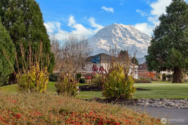 an aerial view of a house with garden space and street view
