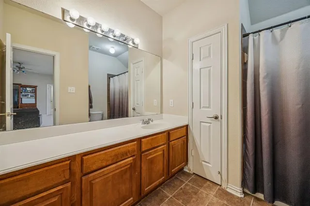 a spacious bathroom with a double vanity sink mirror and