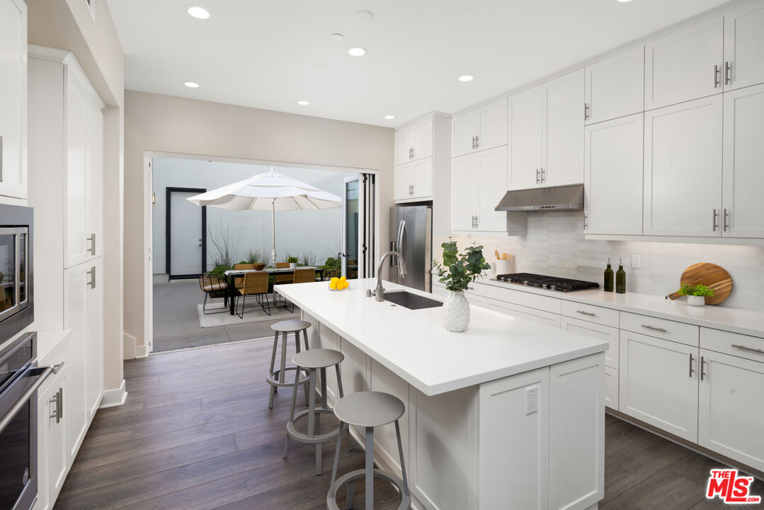 386 Novel Irvine, CA 92618 - Photo 12 of 52 a kitchen with a table chairs refrigerator and cabinets