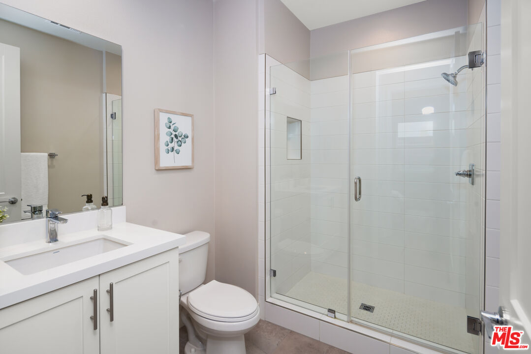 386 Novel Irvine, CA 92618 - Photo 15 of 52 a bathroom with a shower sink vanity mirror and toilet