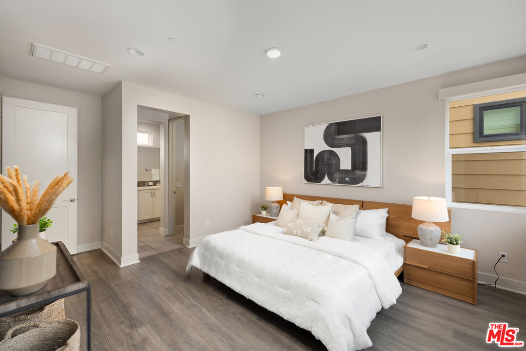 386 Novel Irvine, CA 92618 - Photo 24 of 52 a bedroom with a bed and wooden floor