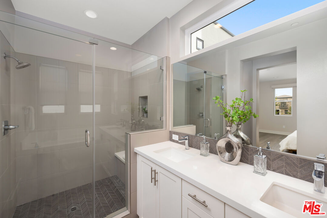 386 Novel Irvine, CA 92618 - Photo 26 of 52 a bathroom with a shower sink vanity granite and mirror