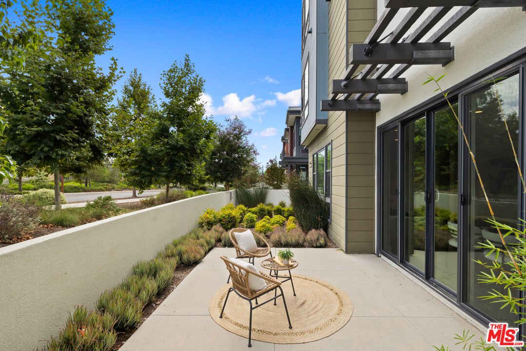386 Novel Irvine, CA 92618 - Photo 37 of 52 a view of a chairs and table in patio with a yard