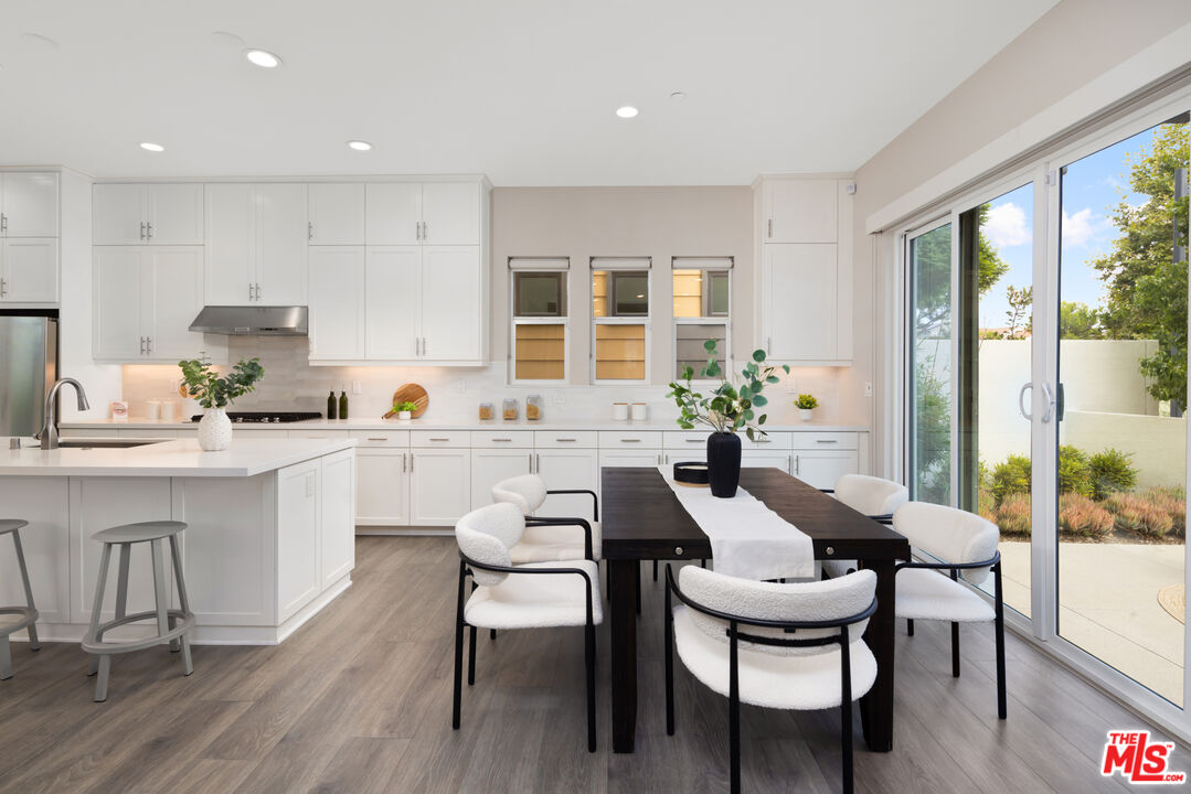 386 Novel Irvine, CA 92618 - Photo 8 of 52 a dining room with furniture and wooden floor