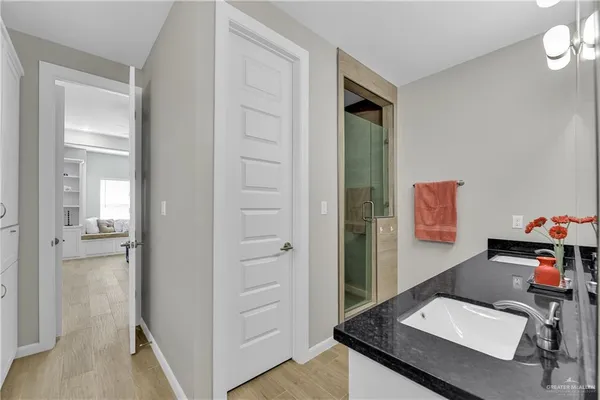 a view of a hallway and a livingroom with wooden floor