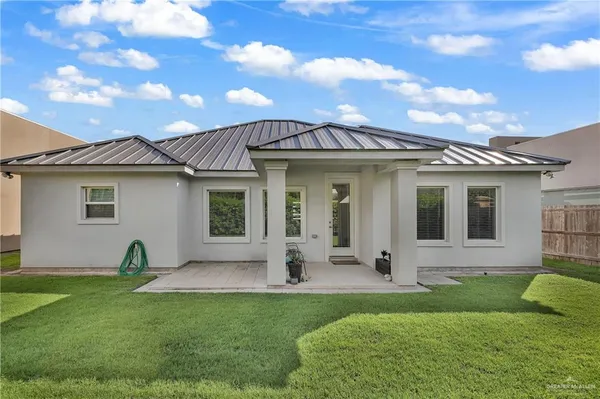 a view of a white house with a yard