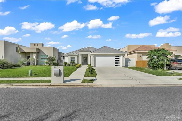 a view of a house with a yard and plants
