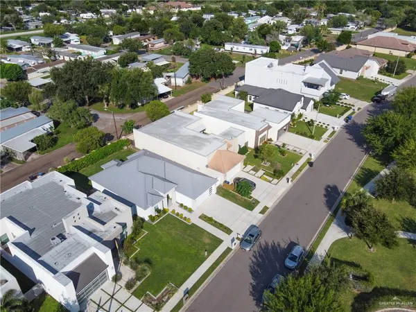 an aerial view of a house with a garden and swimming pool