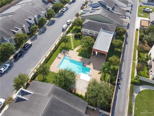 front view of house with a yard and potted plants