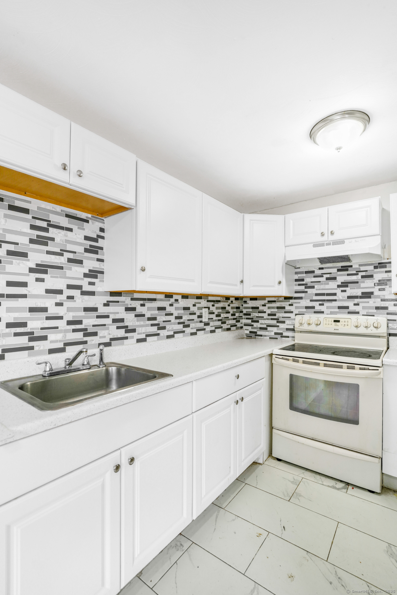 183 Barker Street, Unit A4 Hartford, CT 06114 - Photo 3 of 6 a kitchen with granite countertop white cabinets and white appliances