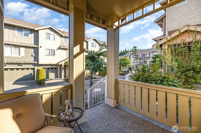 a view of a chairs and table in the balcony