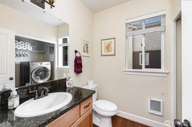 a bathroom with a toilet a sink and a mirror