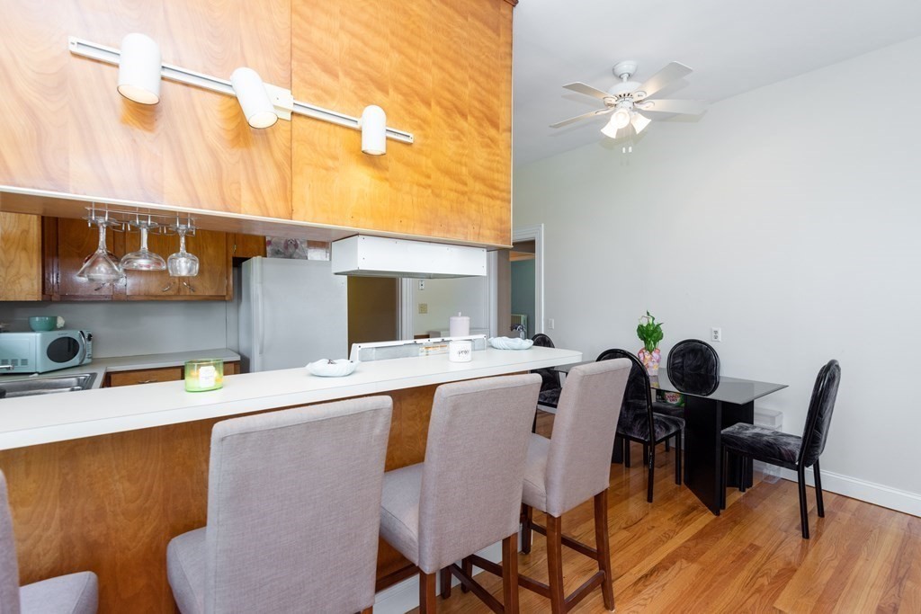 30 Chestnut Street Stoneham, MA 02180 - Photo 12 of 41 a view of a dining room with furniture and wooden floor