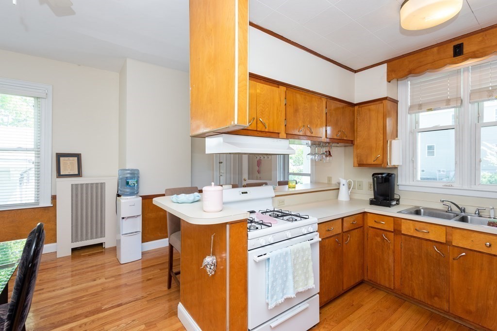 30 Chestnut Street Stoneham, MA 02180 - Photo 13 of 41 a kitchen with stainless steel appliances granite countertop a sink stove and cabinets