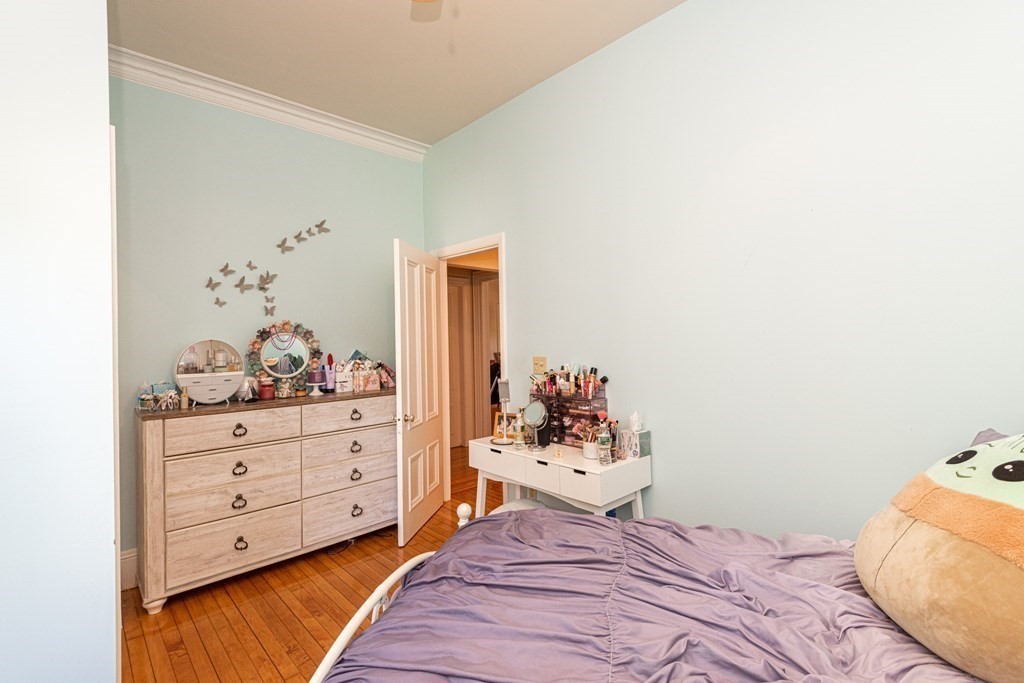 30 Chestnut Street Stoneham, MA 02180 - Photo 19 of 41 a bedroom with a bed and a dresser in it