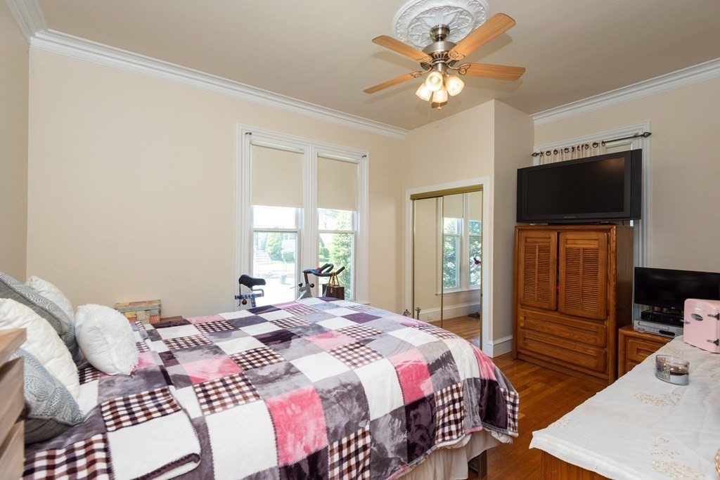 30 Chestnut Street Stoneham, MA 02180 - Photo 21 of 41 a bedroom with a bed and a flat screen tv