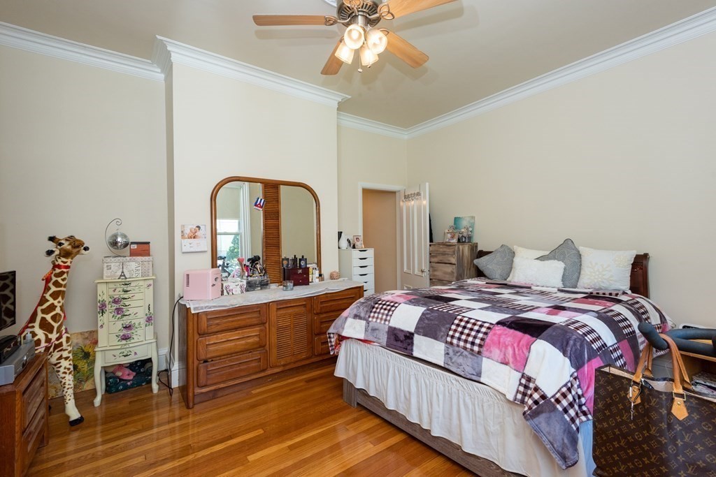 30 Chestnut Street Stoneham, MA 02180 - Photo 22 of 41 a bedroom with bed and a chandelier