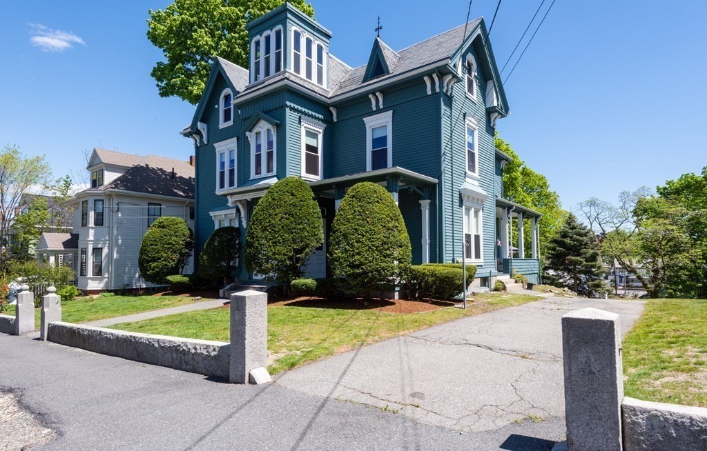 30 Chestnut Street Stoneham, MA 02180 - Photo 3 of 41 a front view of a house with a yard