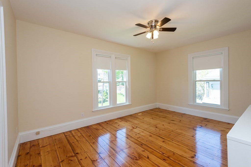 30 Chestnut Street Stoneham, MA 02180 - Photo 32 of 41 an empty room with wooden floor and windows