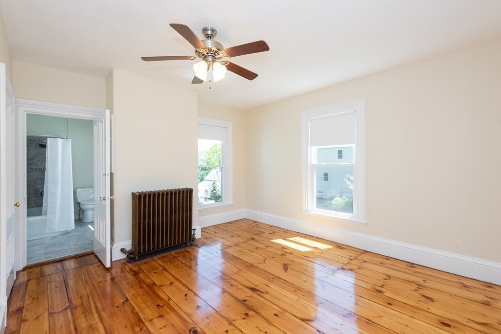 30 Chestnut Street Stoneham, MA 02180 - Photo 34 of 41 an empty room with wooden floor cabinet and windows